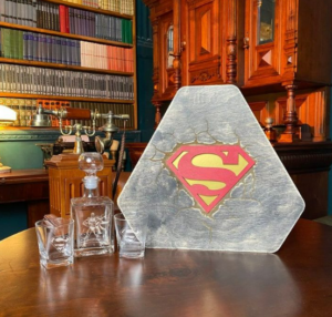 glasses of wine on a brown table showing unique superman gifts for adults 