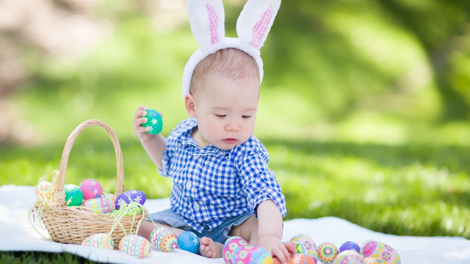 a baby palying with easter eggs showing the best easter gifts for babies 