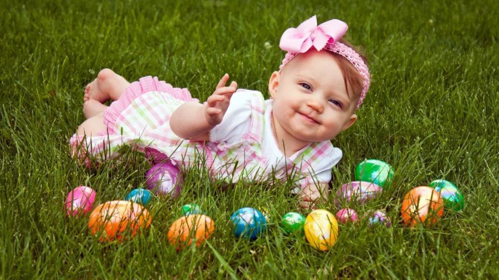 a baby girl playing with easter eggs